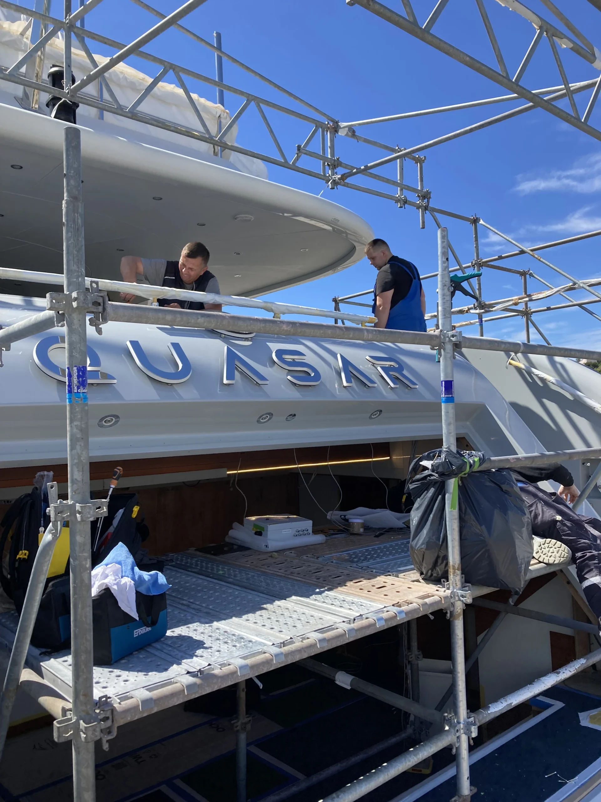 Quasar Scaffording Custom illuminated yacht name sign with IP-rated LED lighting installed on superyacht transom